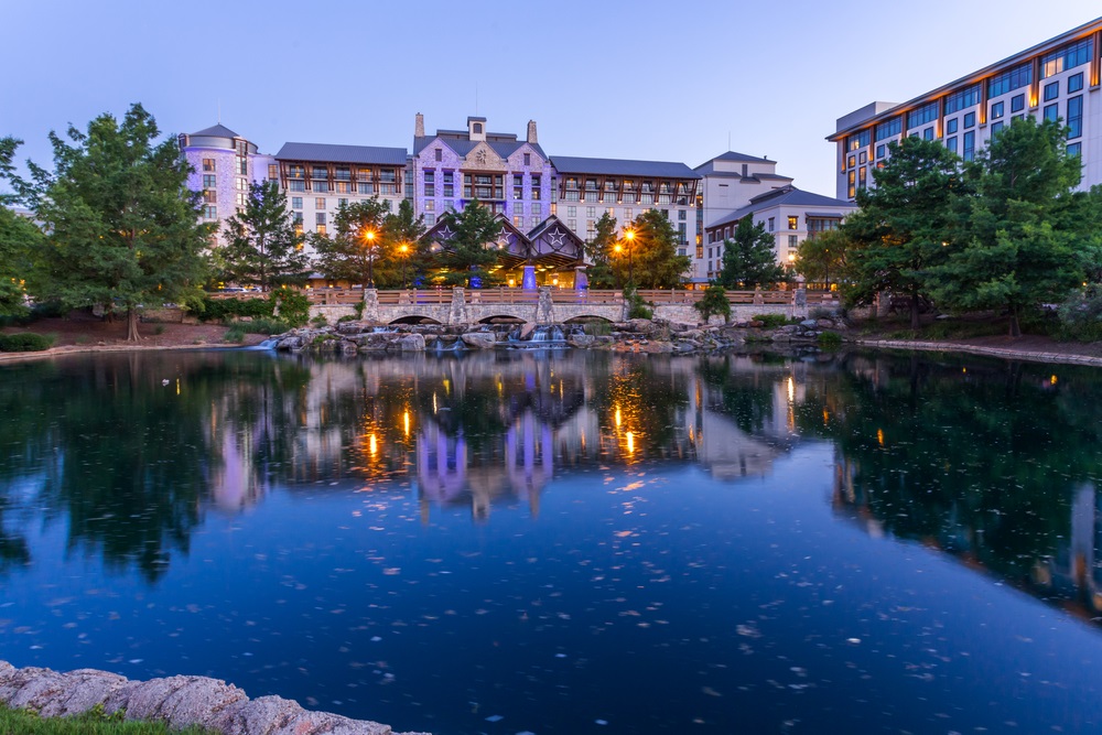 Beautiful Gaylord Texan Resort building over a stone bridge at twilight