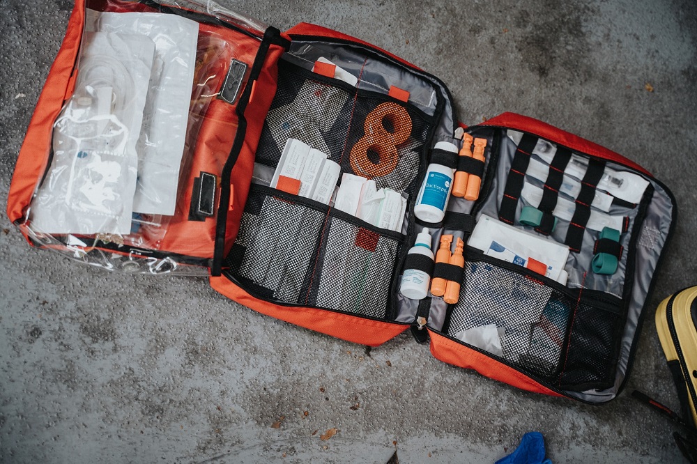 opened first aid kit placed on floor